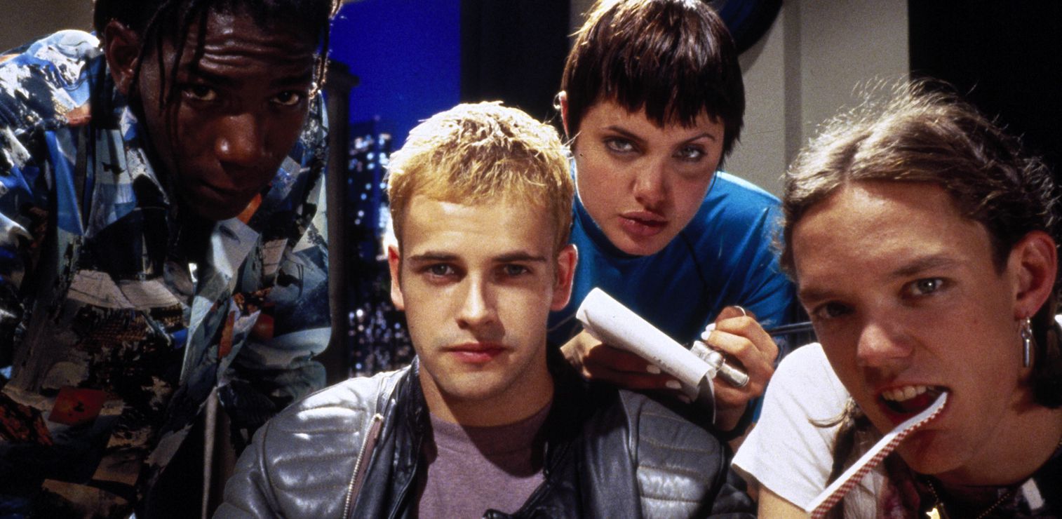Characters from the movie 'Hackers' huddled around computer, looking at viewers